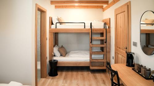 a small room with bunk beds and a ladder at Hiša 88 in Dutovlje