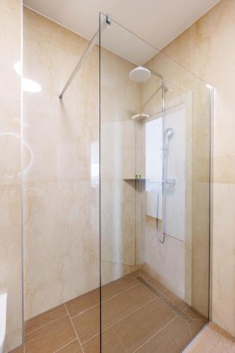 a shower with a glass door in a bathroom at Stella Maris in Podstrana
