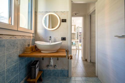 a bathroom with a sink and a mirror at I LAGHEE casette BREVA e TIVANO Lakeside Garden Bike&Boat&Scooter Lake Como in Colico