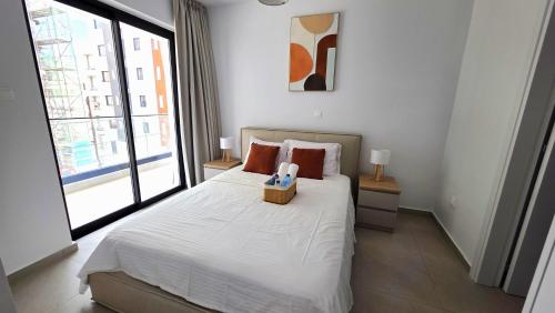 a bedroom with a bed with a box on it at Spacious & Modern - Best Larnaca Location in Larnaca