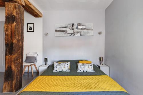 a bedroom with a bed and a chair in it at Chambre d'Hote Familiale in Neuville-du-Poitou