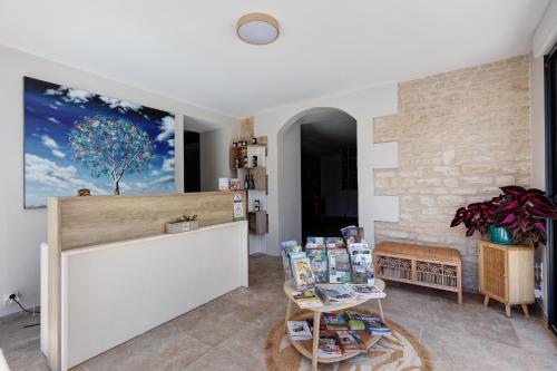 a store with a counter and tables in a room at Chambre d'Hote Familiale in Neuville-du-Poitou