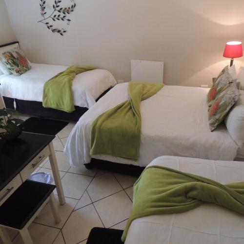 Ένα ή περισσότερα κρεβάτια σε δωμάτιο στο Rita's Guesthouse CC
