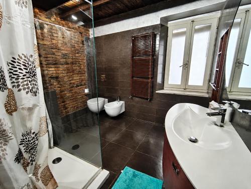 a bathroom with a sink and a shower at Suite Rosso 24 in Iesi