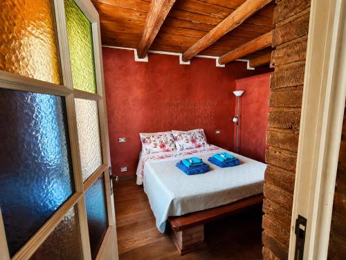 a bedroom with a bed in a red wall at Suite Rosso 24 in Iesi