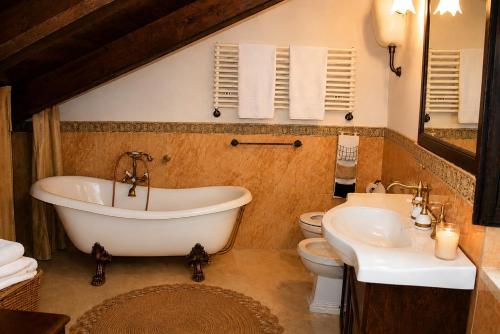 a bathroom with a tub and a toilet and a sink at Villetta Incanto relax in Cava deʼ Tirreni