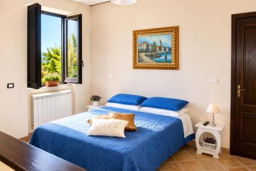 a bedroom with two beds with blue sheets at Villetta Incanto relax in Cava deʼ Tirreni
