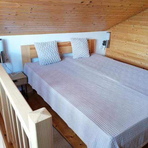 a bedroom with a large bed in a wooden room at Apartman Ružica in Banja