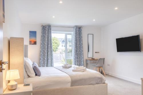 a bedroom with a large bed and a window at 2 Bed in Sandown oc-90013 in Sandown