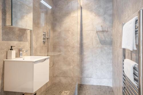 a bathroom with a white sink and a shower at 2 Bed in Sandown oc-90013 in Sandown