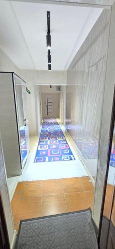 a hallway with a tile floor in a building at ARZON Halal Hotel in Tashkent