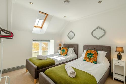 a bedroom with two beds and a window at 6 Bed in Holsworthy oc-89218 in Merryfield