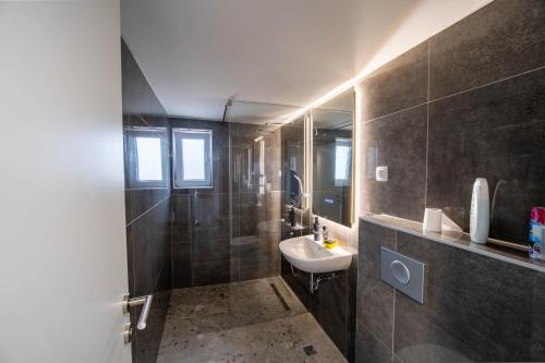 a bathroom with a sink and a mirror at Villa-Vista di Pini Sarajevo in Sarajevo
