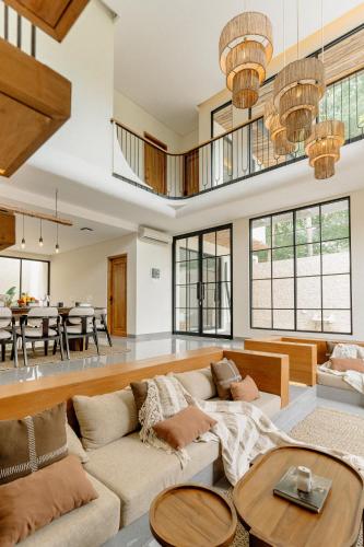 a living room with a couch and a table at Casa Amore 4BR Seminyak in Seminyak
