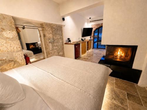 a bedroom with a bed and a fireplace at Adyton Guest House in Didim