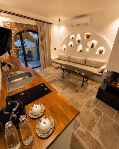 a living room with a couch and a table at Adyton Guest House in Didim