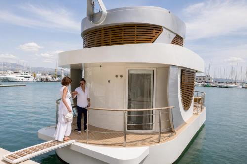 a couple standing on the deck of a yacht at Luxury Floating Apartment - Amor in Split
