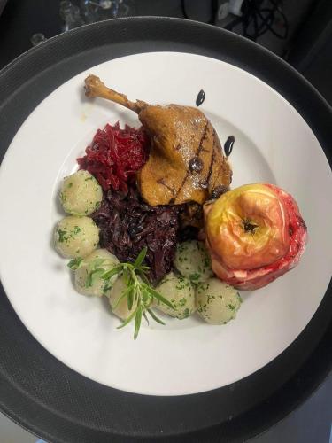 a plate of food with meat and vegetables on it at Kite Marina Sarbsk in Sarbsk