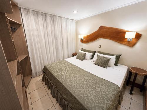 a hotel room with a bed in a room at Tupa Hotel Iguazu in Puerto Iguazú