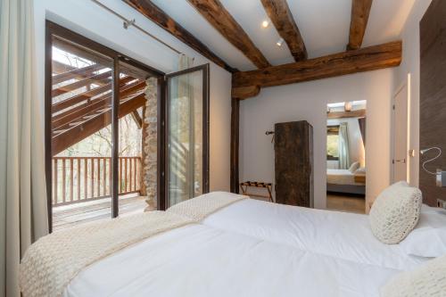 a bedroom with a bed and a large window at Arantza Apartamentuak in Arantza