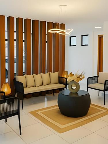 a living room with a couch and a table at Flat no centro VDP314 - Rooftop in Porto De Galinhas