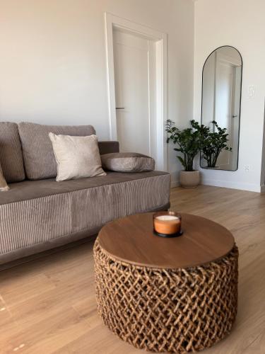 a living room with a couch and a coffee table at Moon&Mori in Augustów