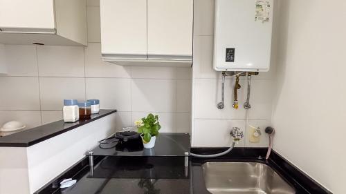 a kitchen with a sink and a counter top at SHB - Refinement, Ocean View, Sauna and Pool! in Santos