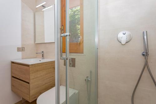 a bathroom with a shower and a toilet and a sink at Paradise Residence Garden in SantʼAlessio Siculo