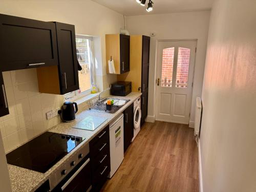 a kitchen with a sink and a counter top at Salisbury City Centre Cottage in Salisbury