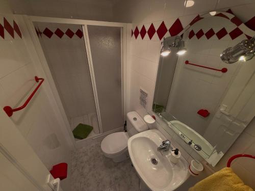 a bathroom with a sink and a toilet and a shower at Playa del Cura - Beachside Retreat in Playa del Cura