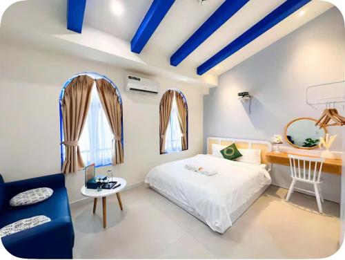 a bedroom with blue ceilings and a bed and a desk at Santo house in Thôn Trường Giang