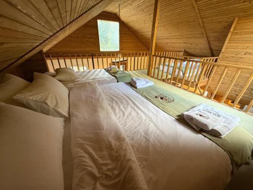 a bedroom with a large bed in a attic at Beel Hills in Khallat al Mutayn