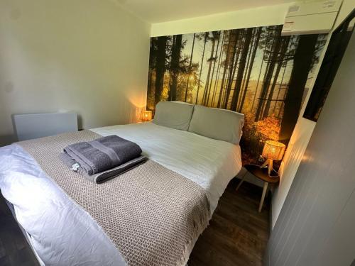 a bedroom with a bed with a painting on the wall at The Truck with private hot tub -Garvagh retreats in Ballynameen