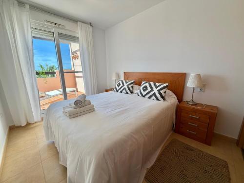 a bedroom with a bed and a large window at Condado de Alhama la isla 7SV2D in El Romero