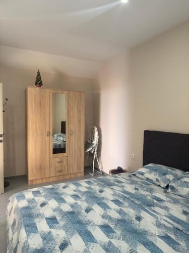 a bedroom with a bed and a wooden cabinet at Ostojic lux apartman in Kotor
