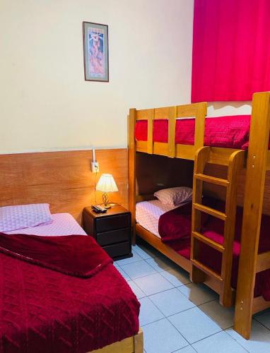a bedroom with two bunk beds and a lamp at KORICANCHA in Lima