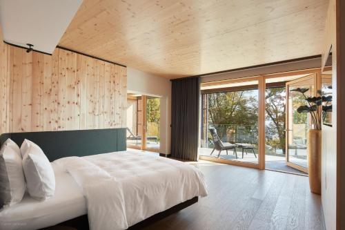 a bedroom with a large bed and a large window at Buff Medical Resort Konstanz in Konstanz
