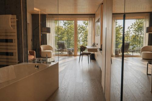 a living room with wood floors and a large window at Buff Medical Resort Konstanz in Konstanz