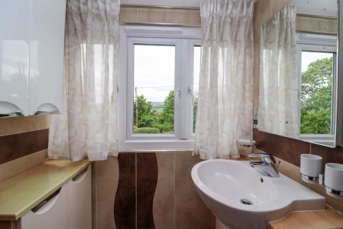 a bathroom with a sink and a window at Meadowcroft in Watchet