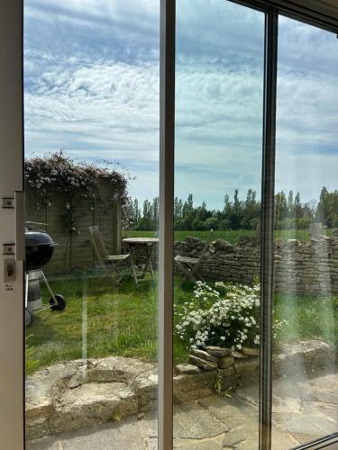a view from a window of a garden at Sunset View - Luxury accommodation in the Cotswolds in Tewkesbury