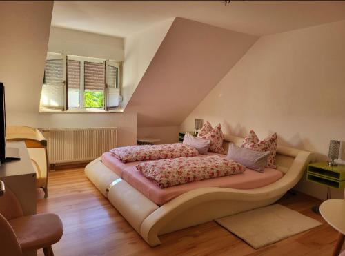 a bedroom with a large bed with pillows on it at Ferienwohnung Erdmännchen in Erfurt