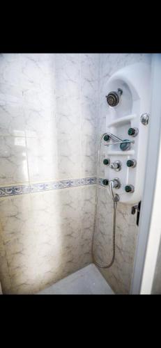 a bathroom with a shower with a shower head at Dolls House in Lagos