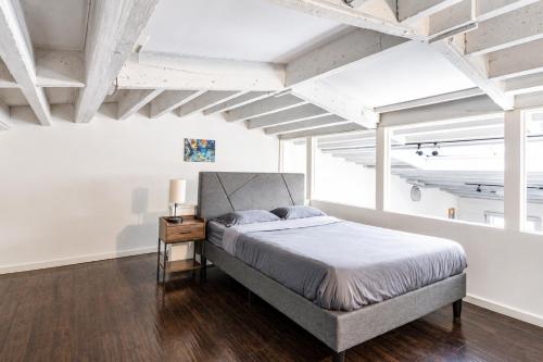 a bedroom with a large bed and a wooden floor at The Havana Lofts in Philadelphia