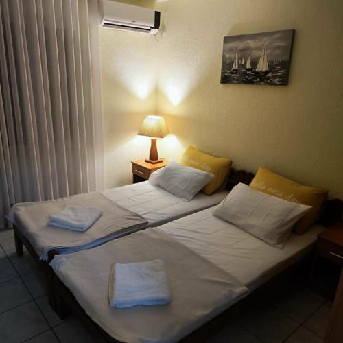 a bedroom with two beds with towels on them at Pine Tree House in Bar