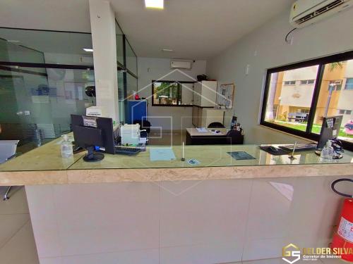 an office with a counter with two computers on it at Flats CTC Araras in Caldas Novas