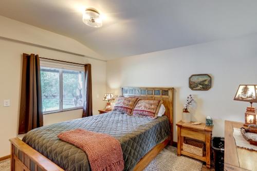 a bedroom with a bed and a window at On the Flathead River! Rustic Saloon-Themed Cabin in Columbia Falls
