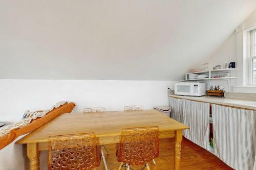 a kitchen with a wooden table and chairs at Charming cottage close to the beach in Truro
