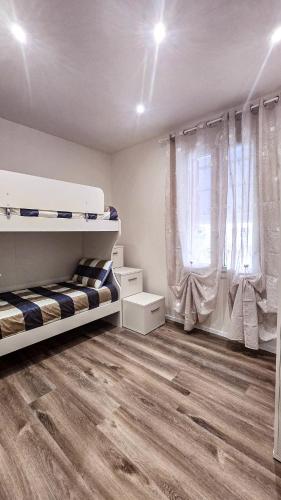 a bedroom with two bunk beds and a wooden floor at B&B di Cristina in Conegliano