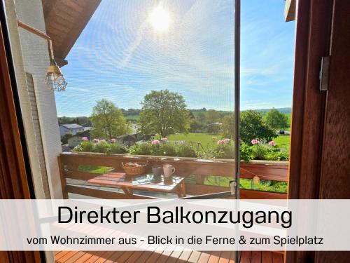 an open window with a view of a garden at Ferienwohnung Matheaperle mit Infrarotkabine in Nidda