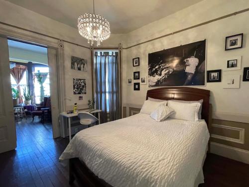 a bedroom with a bed and a chandelier at B-Love's Guest House in Oakland
